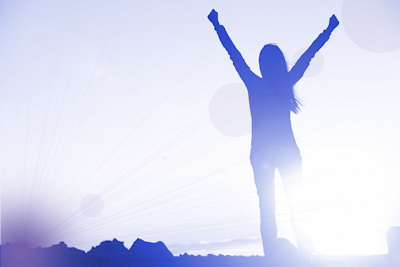 Woman triumphant at sunrise